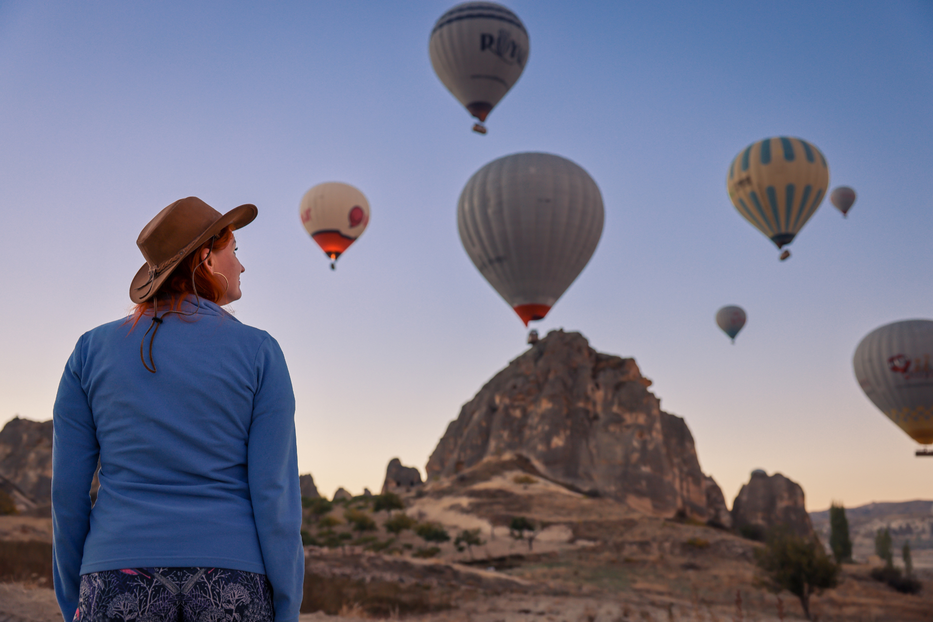 Balloons in the morning in Cappadocia and tourist watching