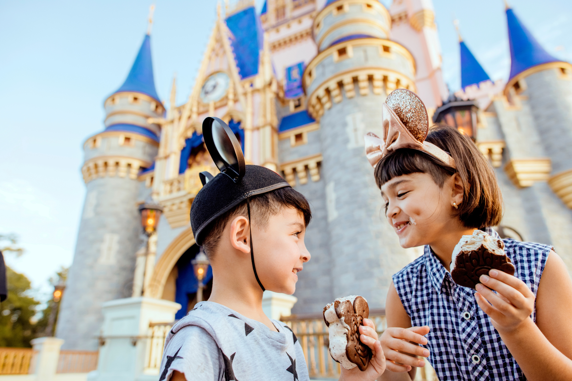 Children eating Micky Ice Cream in front of Disney Castle