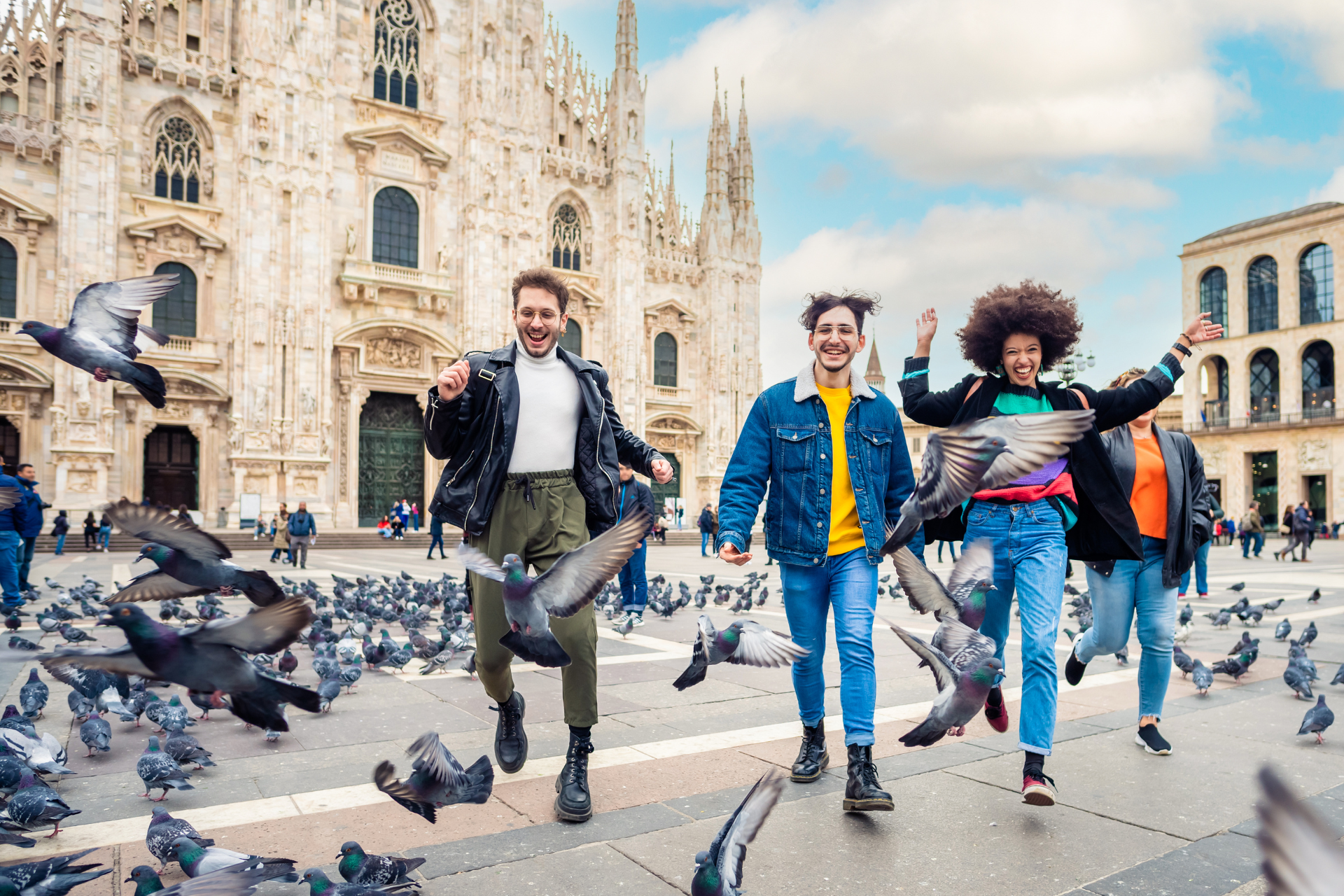 People chasing pigeons in Duomo Square in Milan, Italy