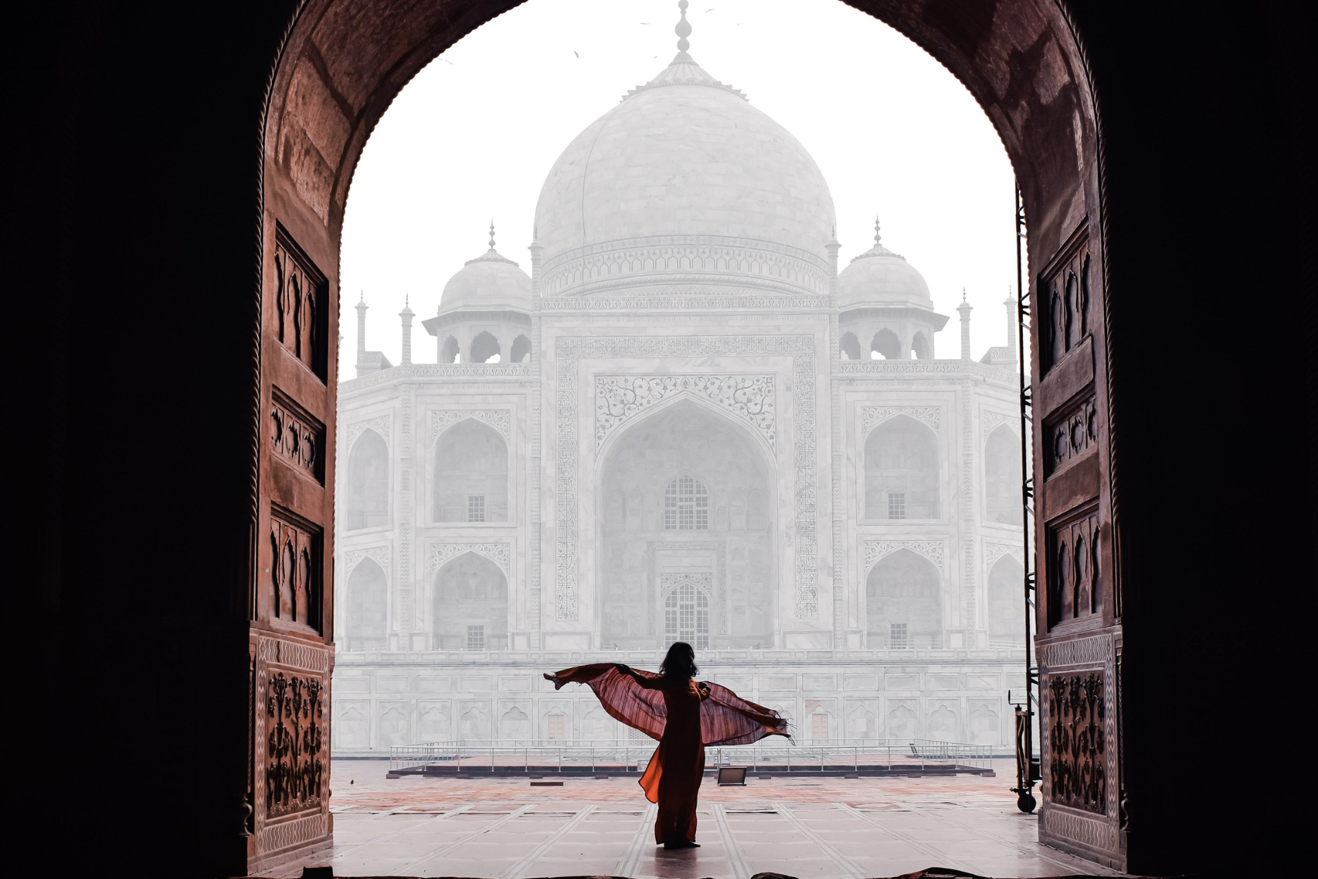 Tourist posing in front of Taj Mahal